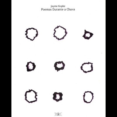 Capa de livro branca com manchas pretas e texto no topo.