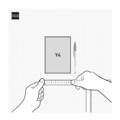 Mãos a medir com régua em folha quadriculada perto de caderno Y4 e caneta