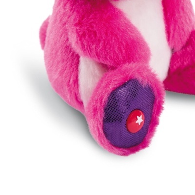 Pata inferior de peluche cor-de-rosa com botão vermelho e estrela branca