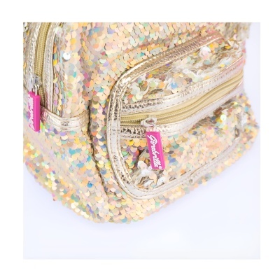 Mochila pequena com lantejoulas douradas e coloridas e etiquetas rosa com texto