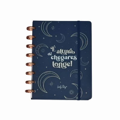 Caderno azul com luas e texto inspirador na capa