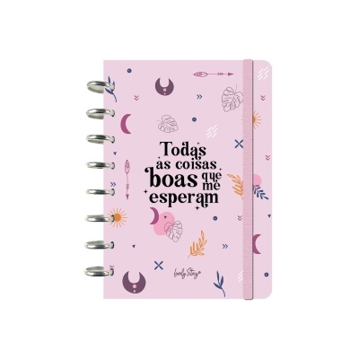 Caderno rosa com elástico e texto inspirador