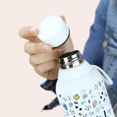 Garrafa térmica branca com padrões coloridos segura com tampa removível