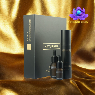 Conjunto de cosméticos NATURNUA em embalagens pretas com texto dourado sobre tecido dourado