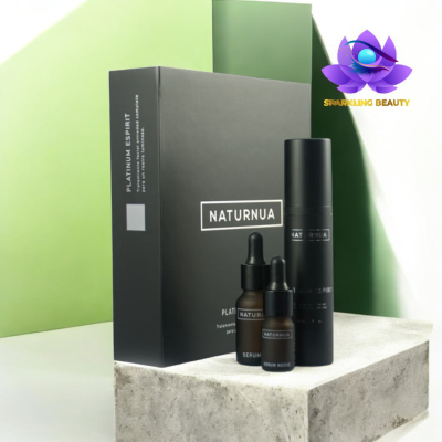 Produto cosmético NATURNUA com frascos e embalagem preta sobre base de pedra