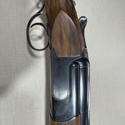 Espingarda de caça canos lado a lado com coronha em madeira escura