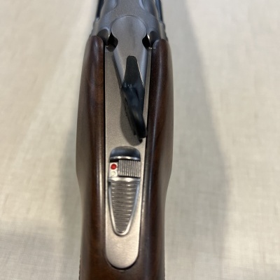 Espingarda com coronha em madeira castanha e partes metálicas prateadas