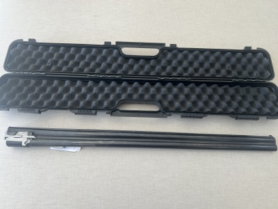 Estojo preto aberto com espuma e arma longa metálica preta ao lado