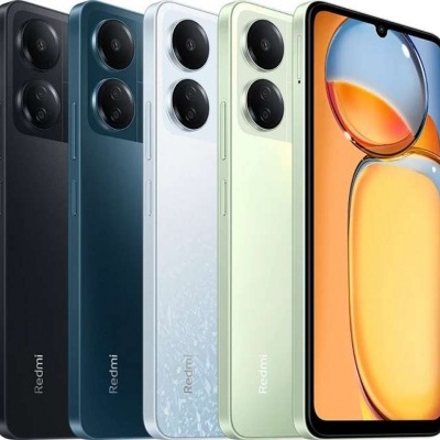 Cinco smartphones Redmi em várias cores, quatro a mostrar a traseira e um a mostrar a frente com ecrã ligado