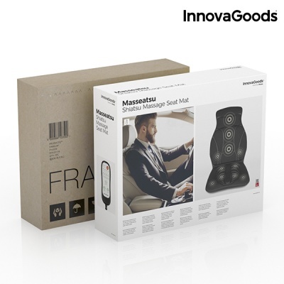 Tapete de massagem shiatsu preto com círculos brancos e controlo remoto branco na embalagem