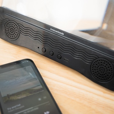 Coluna portátil InnovaGoods preta com padrão ondulado e smartphone ao lado