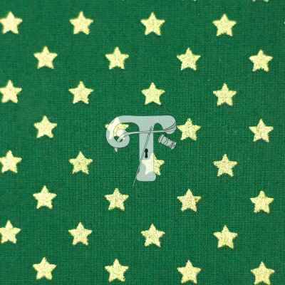 tecido verde com estrelas douradas pequenas em padrão repetido
