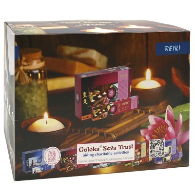 Caixa de incenso Goloka Seva Trust com decoração de vela acesa e flor rosa