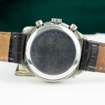 Relógio em metal e pele castanha visto de trás