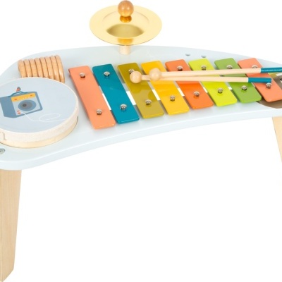 Instrumento musical infantil com xilofone colorido, pandeiro e prato montados numa base branca com pernas de madeira.