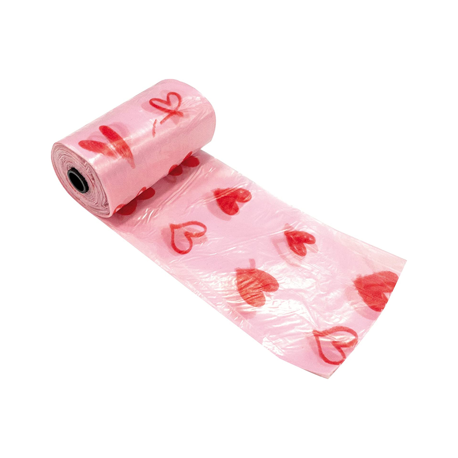 Rolo de saco plástico cor-de-rosa com corações vermelhos