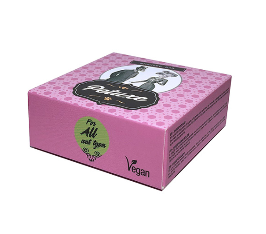 Caixa rosa de perfume vegano com selo verde e texto em inglês