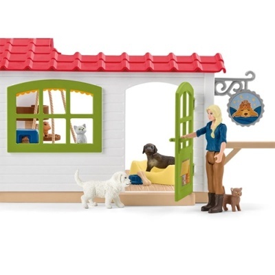 Casa de brinquedo para cães com figuras de animais e pessoa