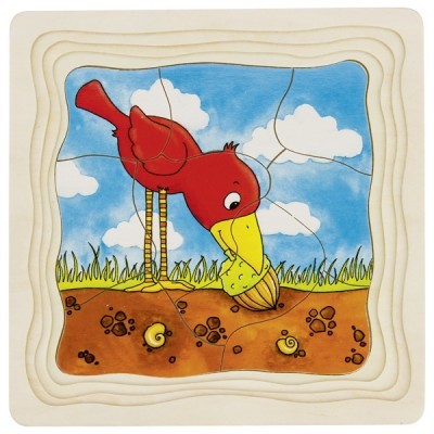 Quebra-cabeça de madeira com desenho de pássaro vermelho no solo com céu azul