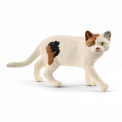 Figura de gato calico com textura que simula pelo, olhos amarelos e manchas castanhas e pretas