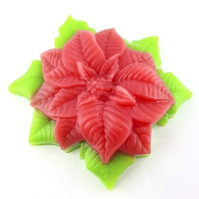 Flor decorativa vermelha com folhas verdes em fundo branco