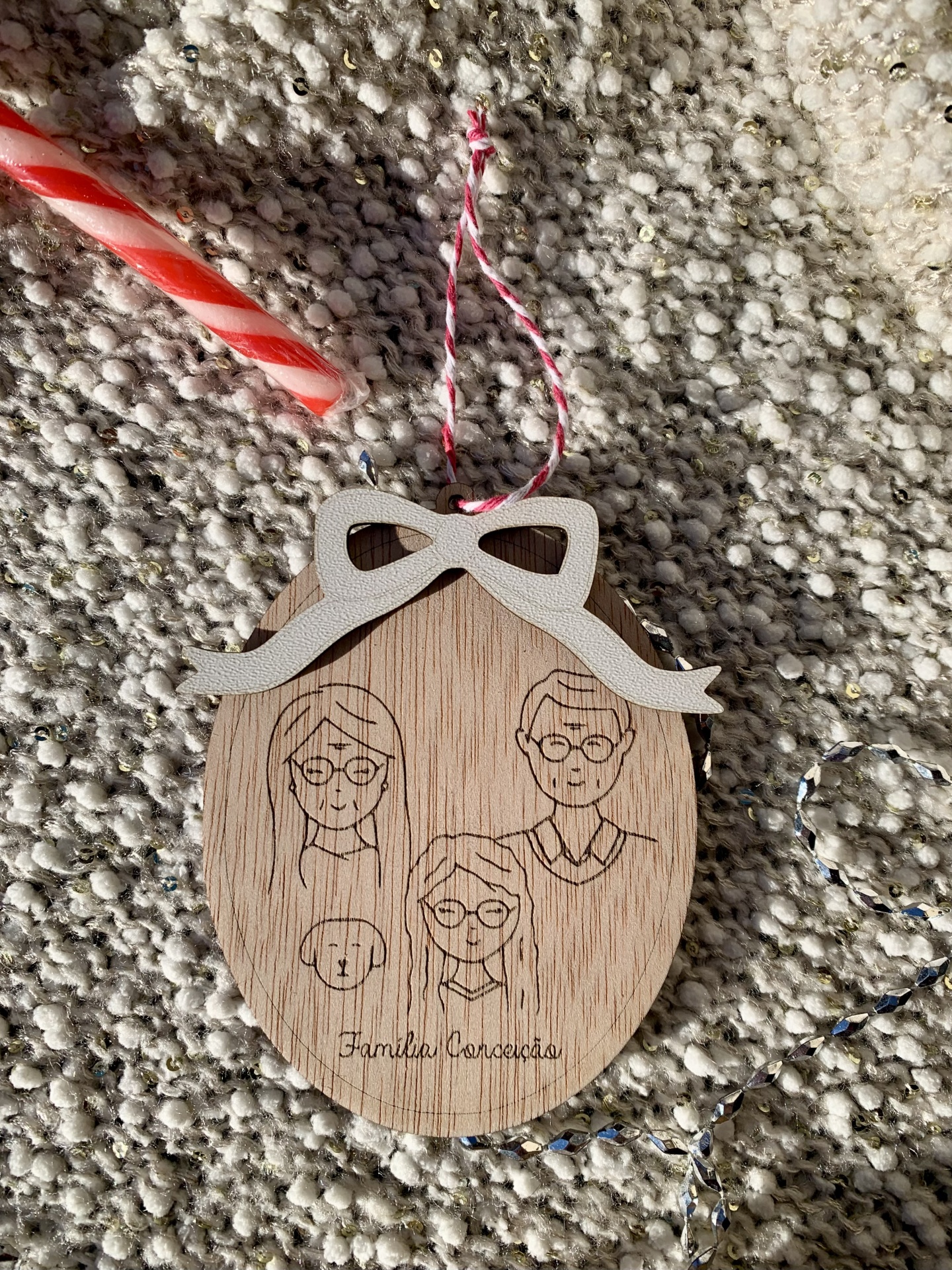 Enfeite oval de madeira com laço branco e gravura de família para pendurar